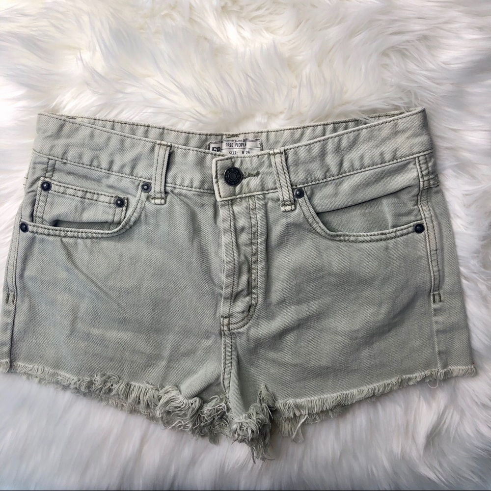FREE PEOPLE. Light green raw hem jean shorts.